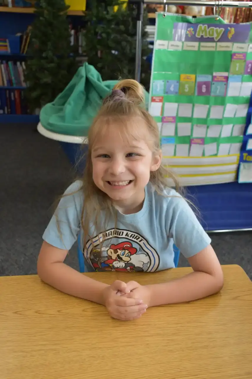 A student smiling at the camera