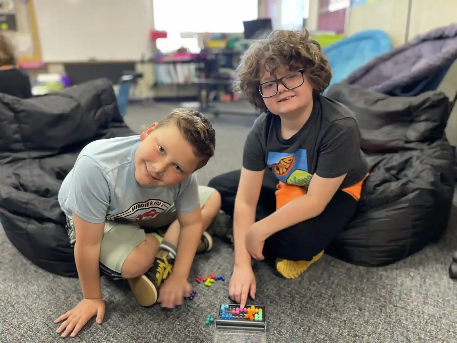 Students building together on the classroom floor