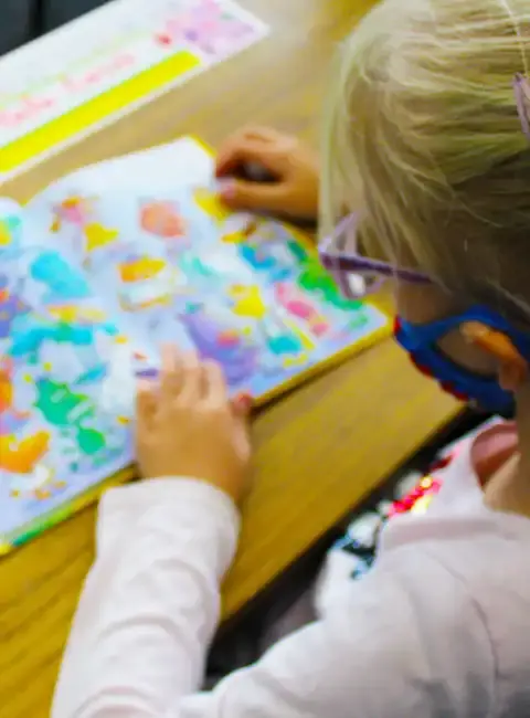 A preschooler coloring a bright picture