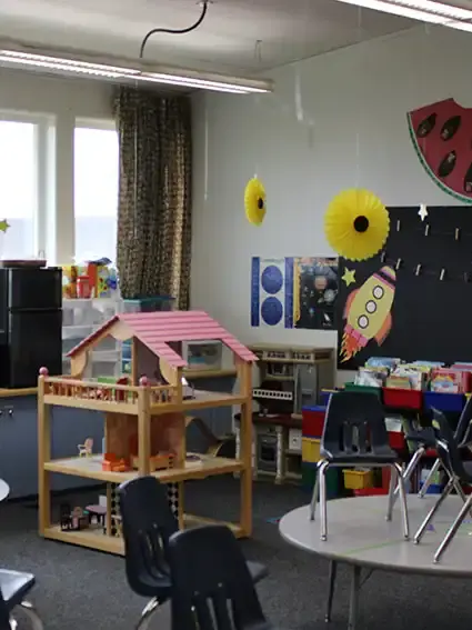 The classroom reading corner with small tables and chairs